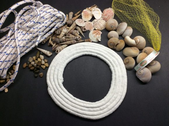 I've been feeling very inspired by seashells lately, finding different ways to work them into my decor.  One of my recent creations is this nautical seashell wreath, which would be a great way to use souvenirs from a beach vacation. Even if you don't have shells and rope on hand, you should still be able to make this for just a few dollars. 