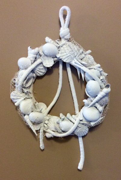 I've been feeling very inspired by seashells lately, finding different ways to work them into my decor.  One of my recent creations is this nautical shell wreath, which would be a great way to use souvenirs from a beach vacation. Even if you don't have shells and rope on hand, you should still be able to make this for just a few dollars. 