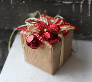 Dollar store gift wrap: faux bois contact paper, raffia & jingle bells