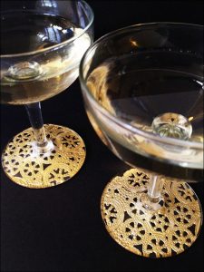 Make gilded lace champagne glasses (via dollarstorecrafts.com)