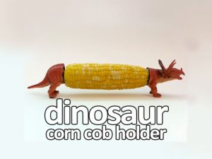 DIY corn cob holders with plastic dinosaurs