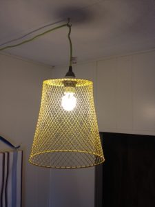 make an industrial-style cage lamp shade out of a dollar store trash can