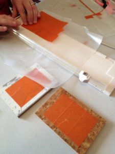 Trimming FrogTape® on wax paper to make a specific shape