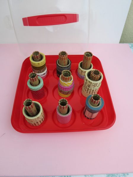 Make a DIY washi tape organizer from a cupcake carrier and free coin rolls from the bank.