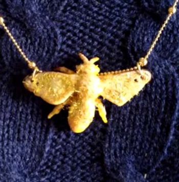 Glitter Bee Necklace - Elevate a cheap plastic bee with a sparkly makeover, turning it into a trendy necklace.